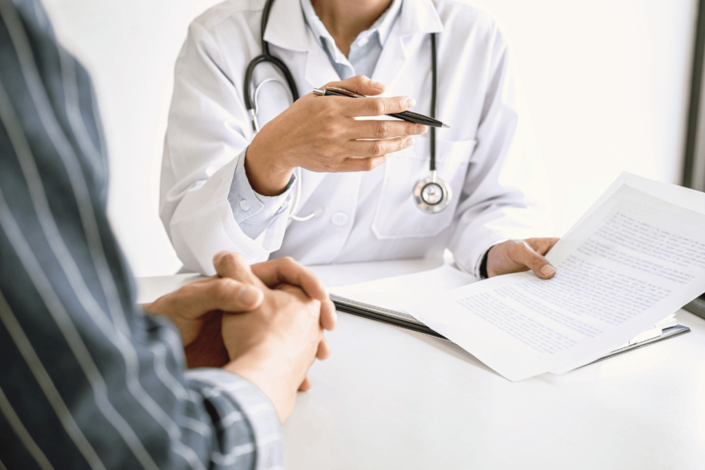 Doctor reviewing blood test results and discussing possible causes of ongoing fatigue with a patient.