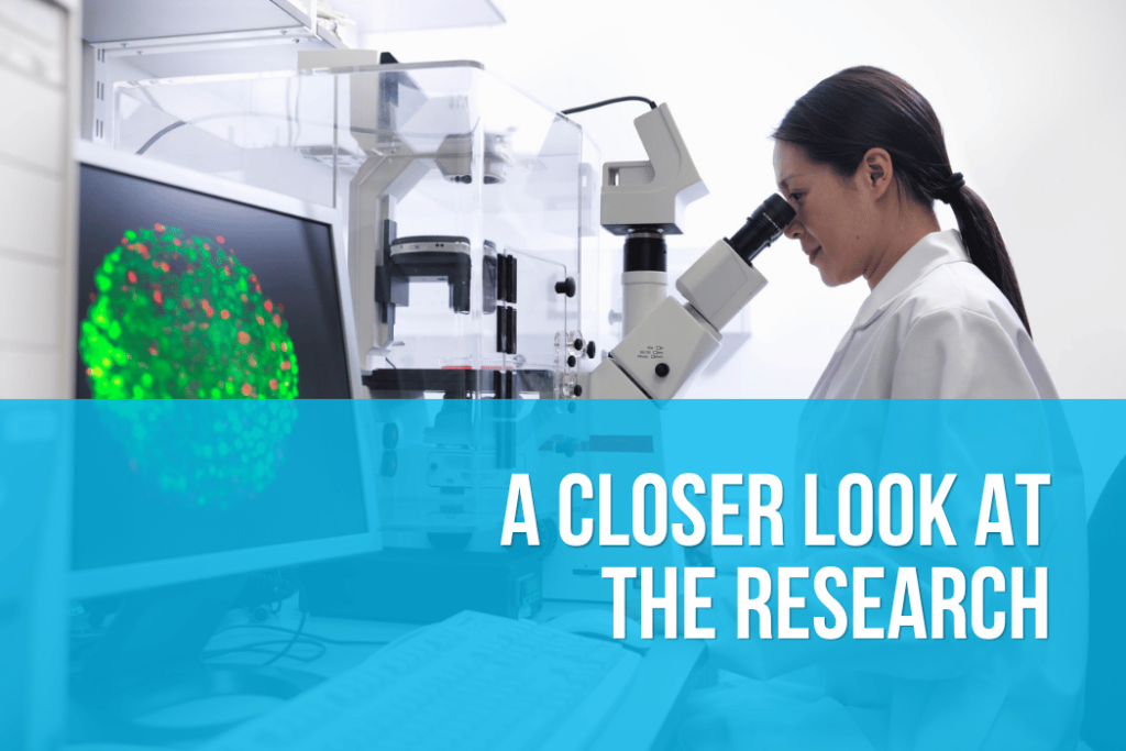Researcher examining cells under a microscope during PEMF laboratory research.